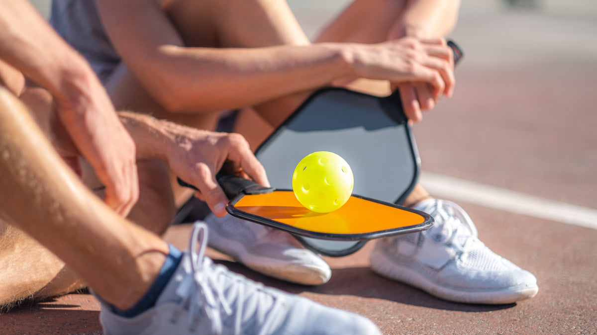 Pickleball rules guide — player on a pickleball court learning the basics