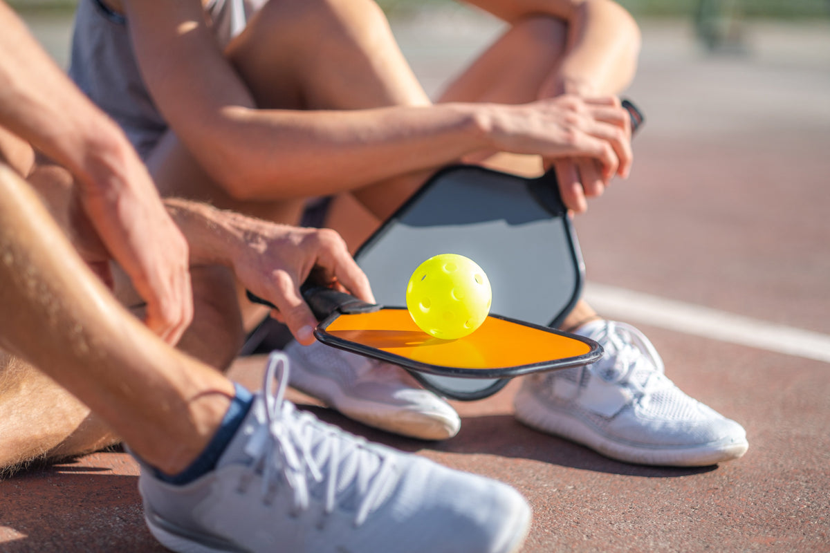 Pickleball rules guide — player on a pickleball court learning the basics