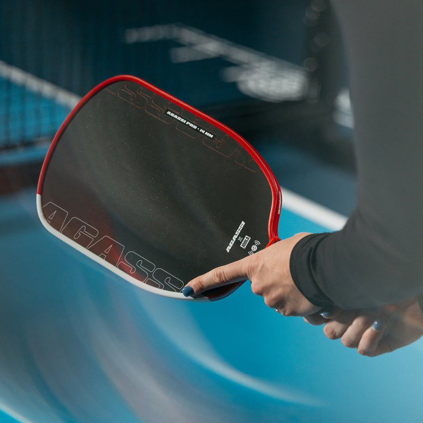 Player holding JOOLA Agassi Pro 14mm paddle